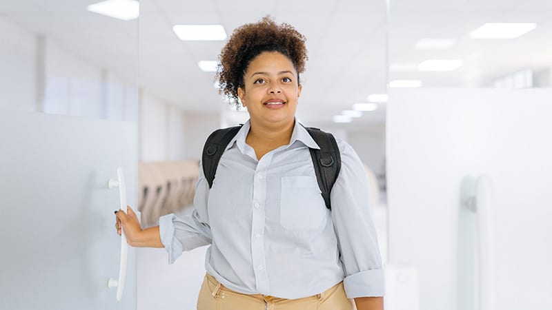 Young woman walking in company departments