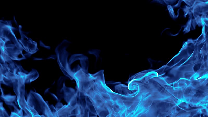 Blue fire isolated on black background.